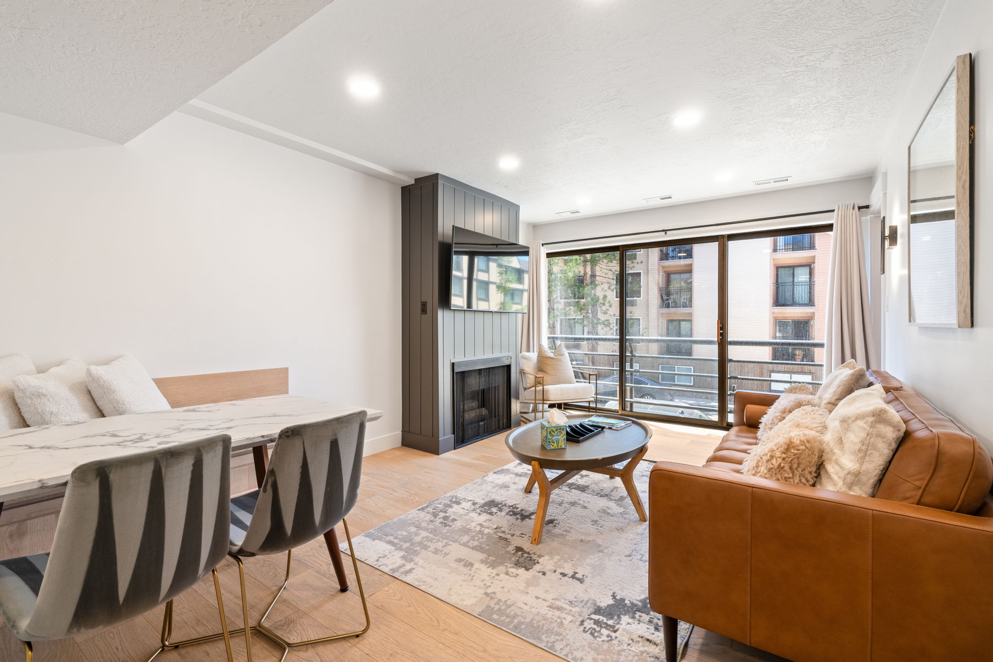 Open-concept living area featuring light wood-finish flooring and recessed lighting