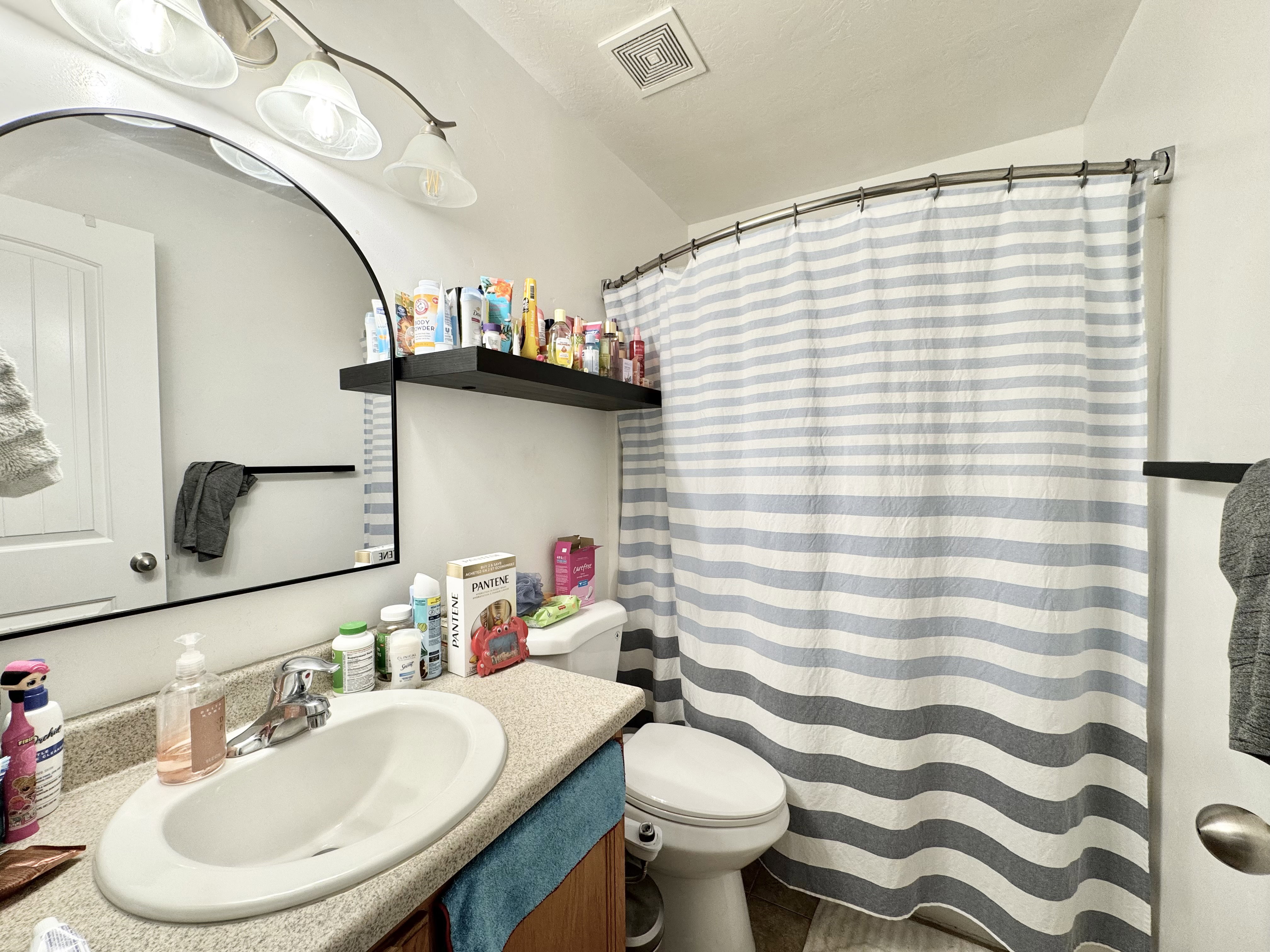Bathroom vanity with an oval sink and speckled countertop
