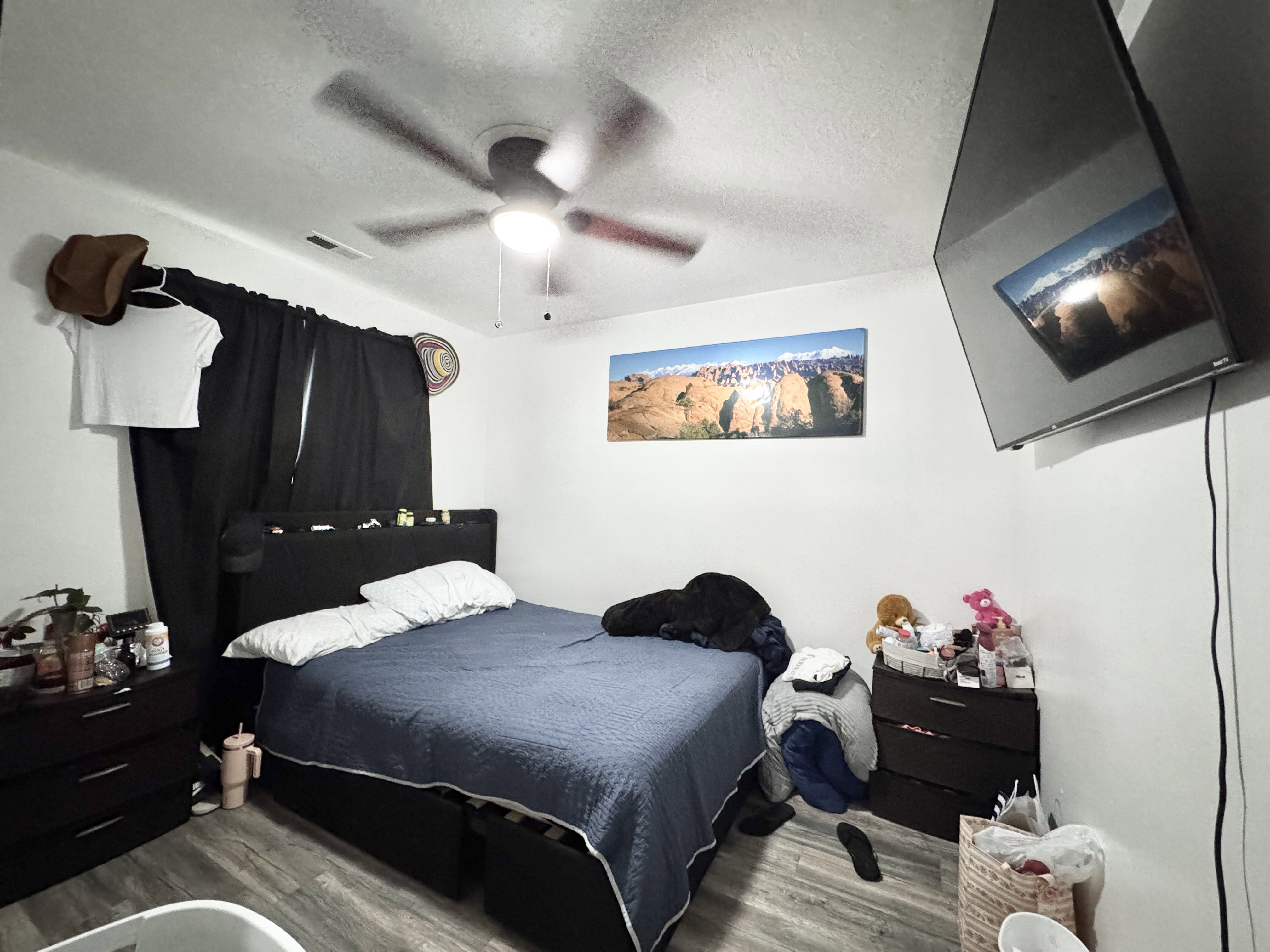 Room with wood-finish flooring and white walls