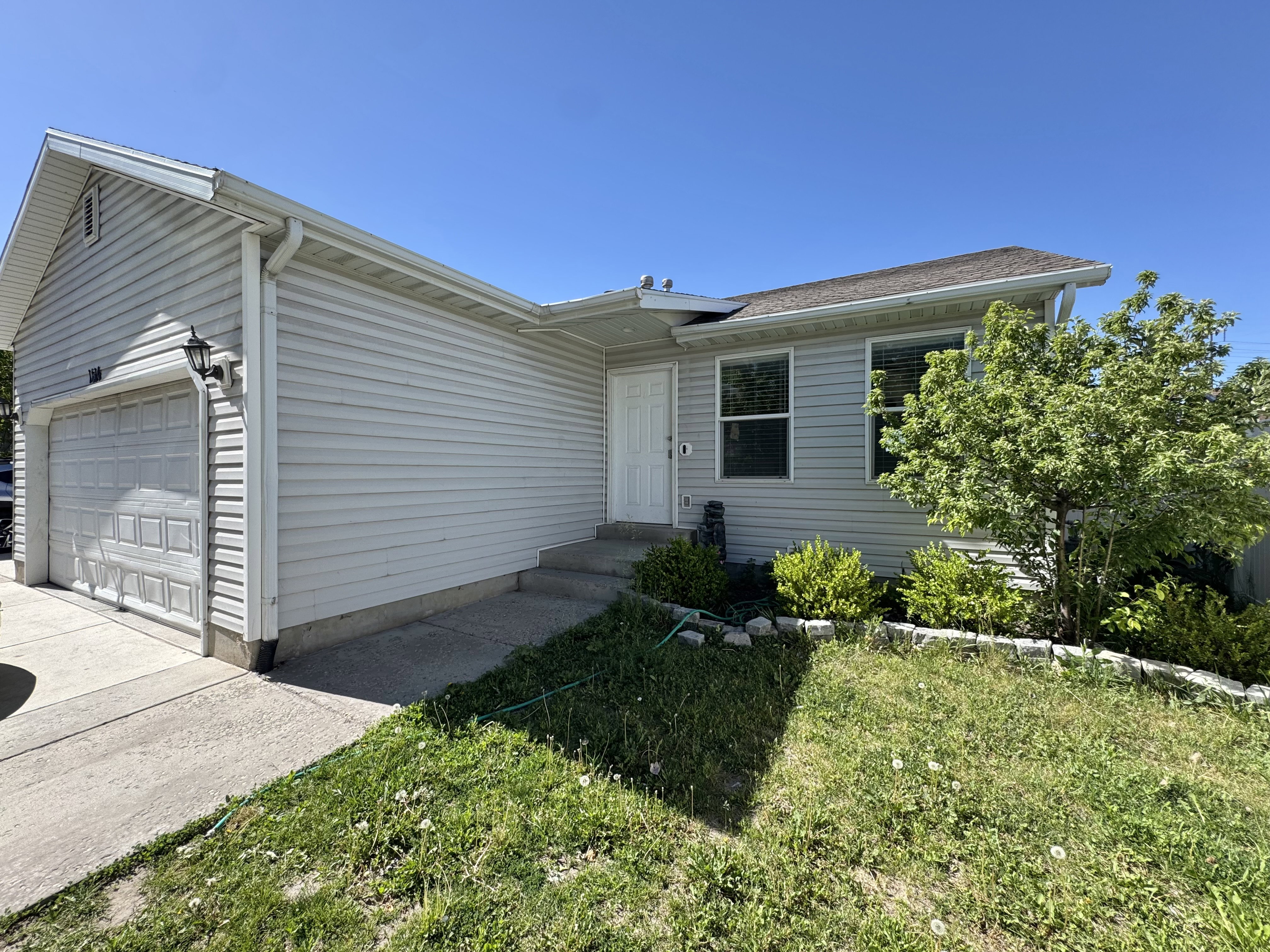 Exterior featuring horizontal siding, a single-car garage, and a concrete driveway