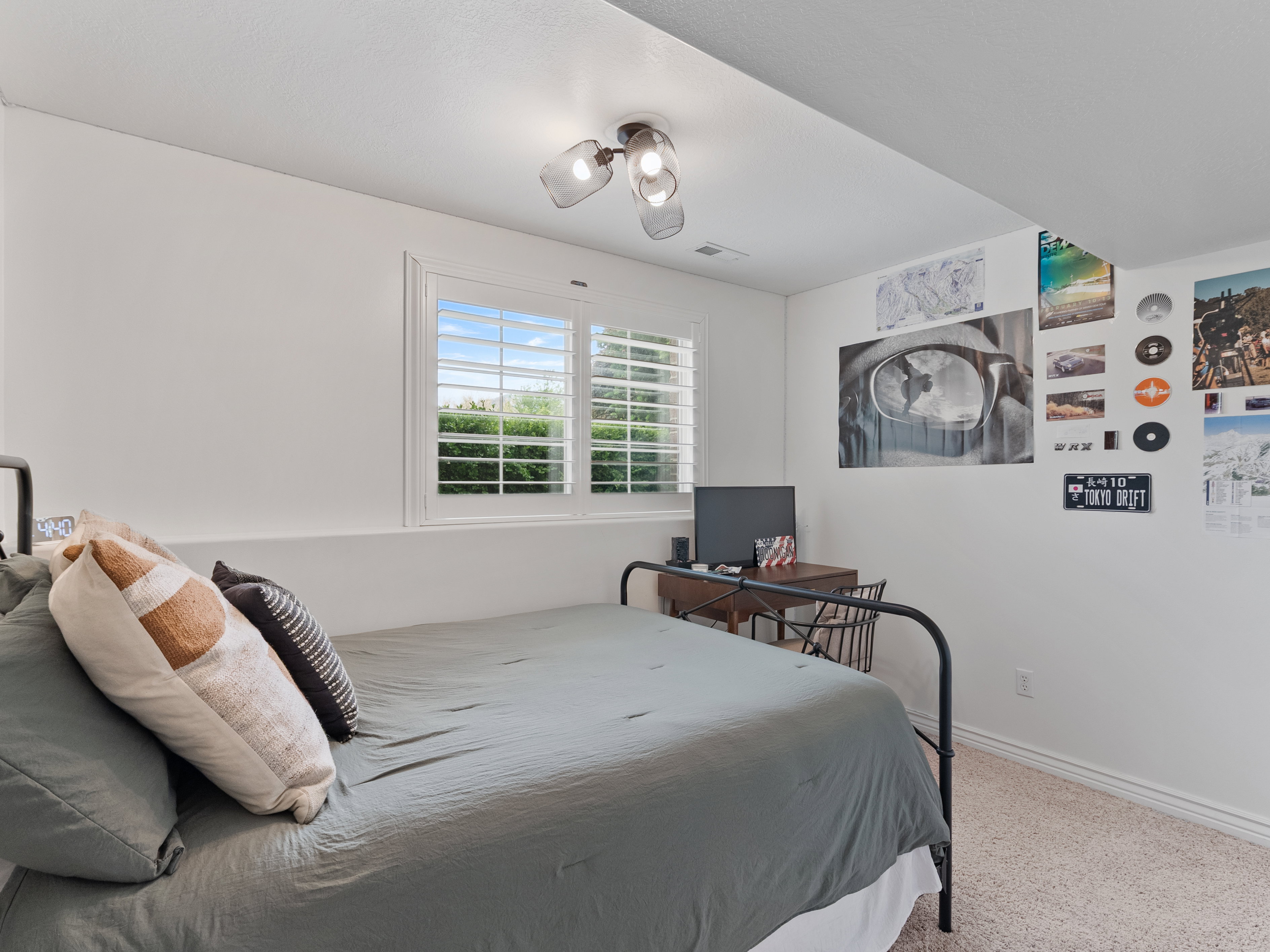 Room featuring white walls, a double window with white plantation shutters, and a semi-flush mount ceiling light fixture