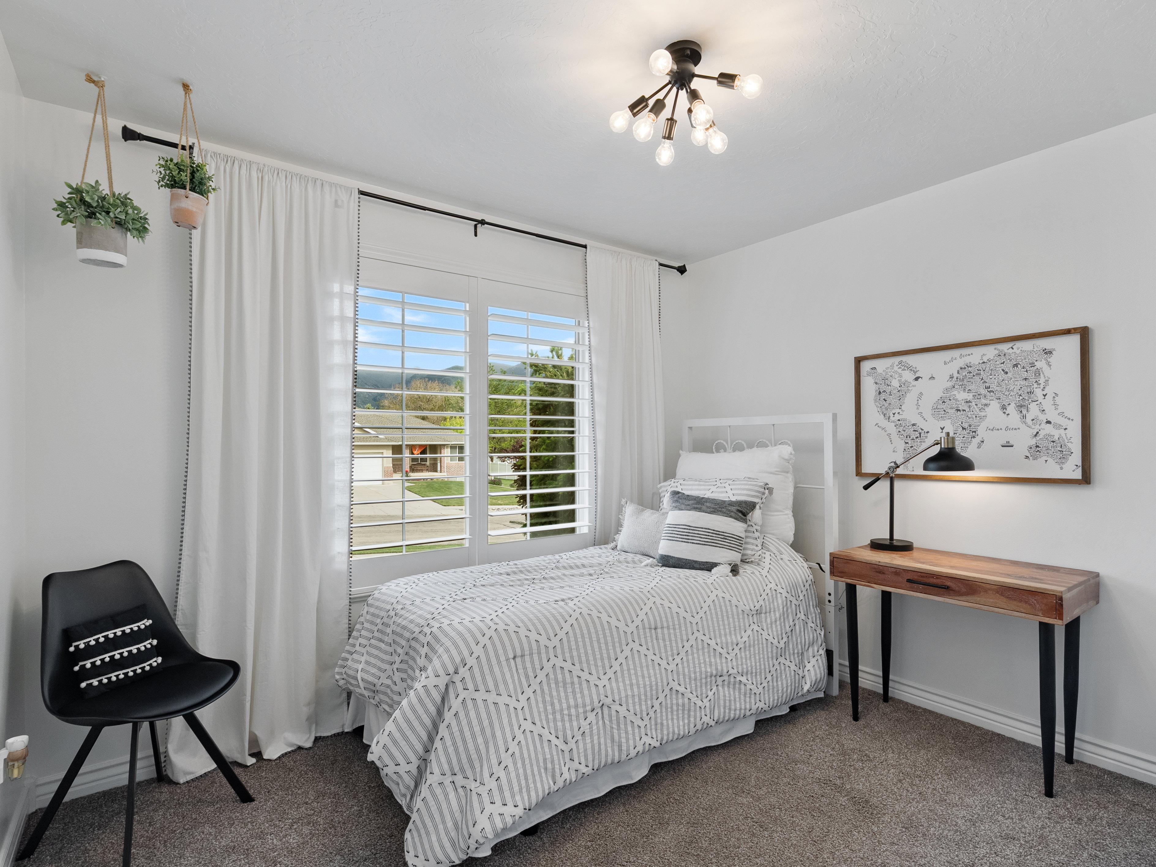 White walls complementing plush carpeting and a modern ceiling light fixture