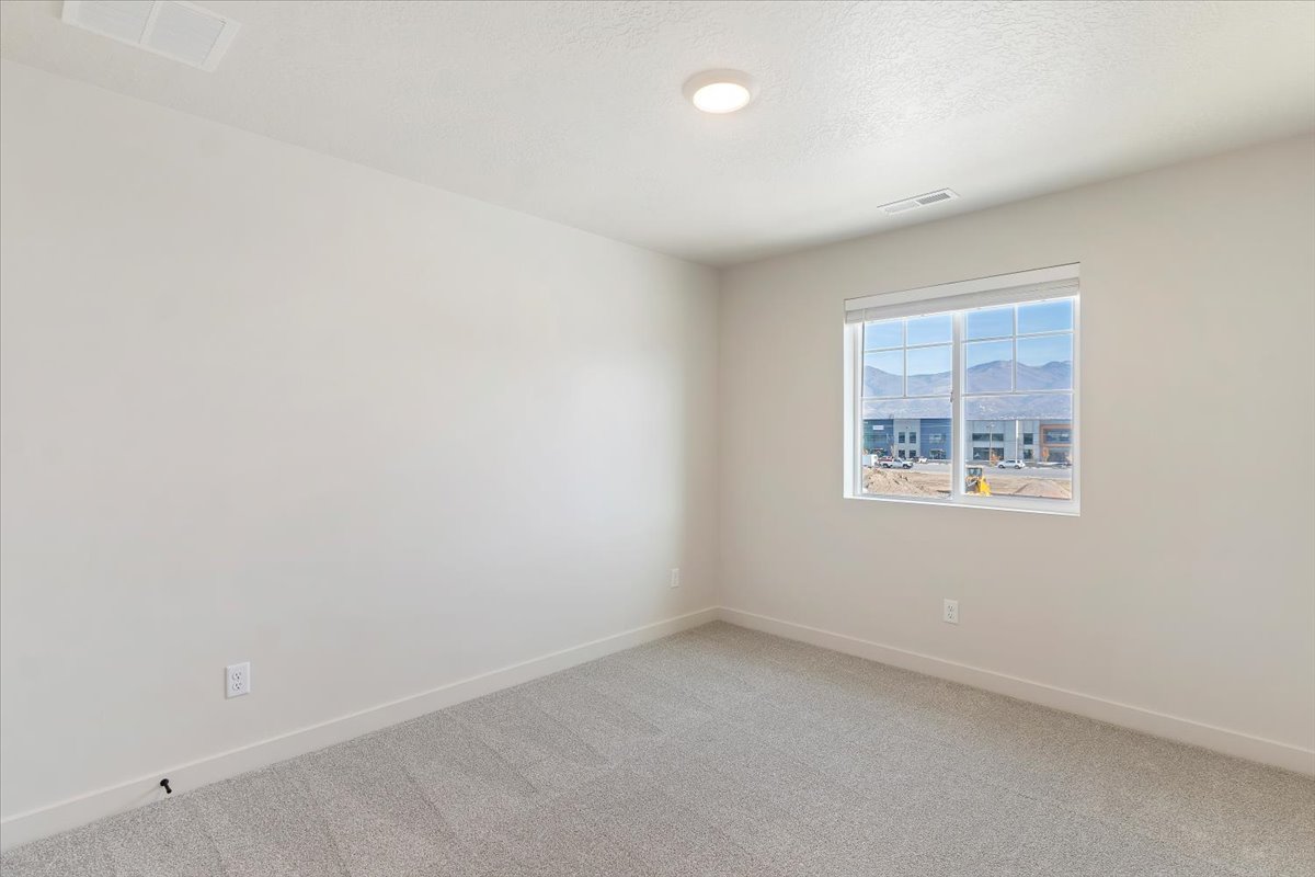Bright interior space featuring a window with a mountain backdrop