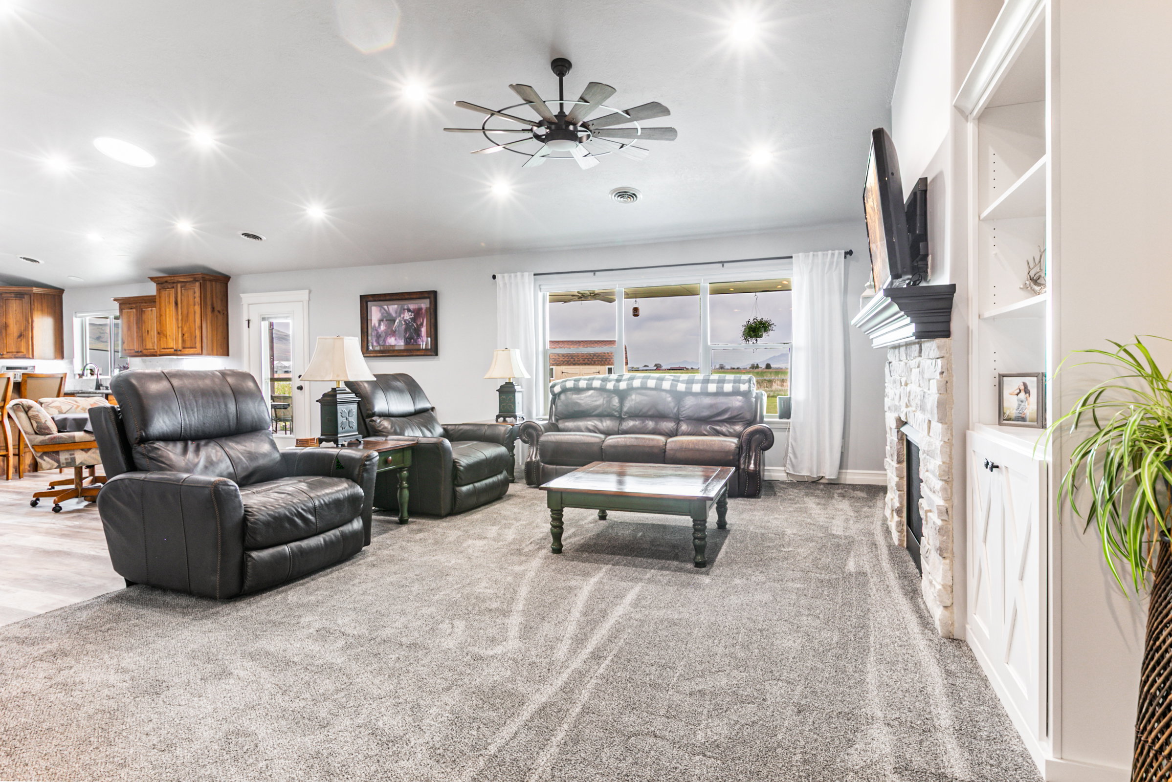 Spacious living area featuring recessed lighting, a ceiling fan, and grey carpeting