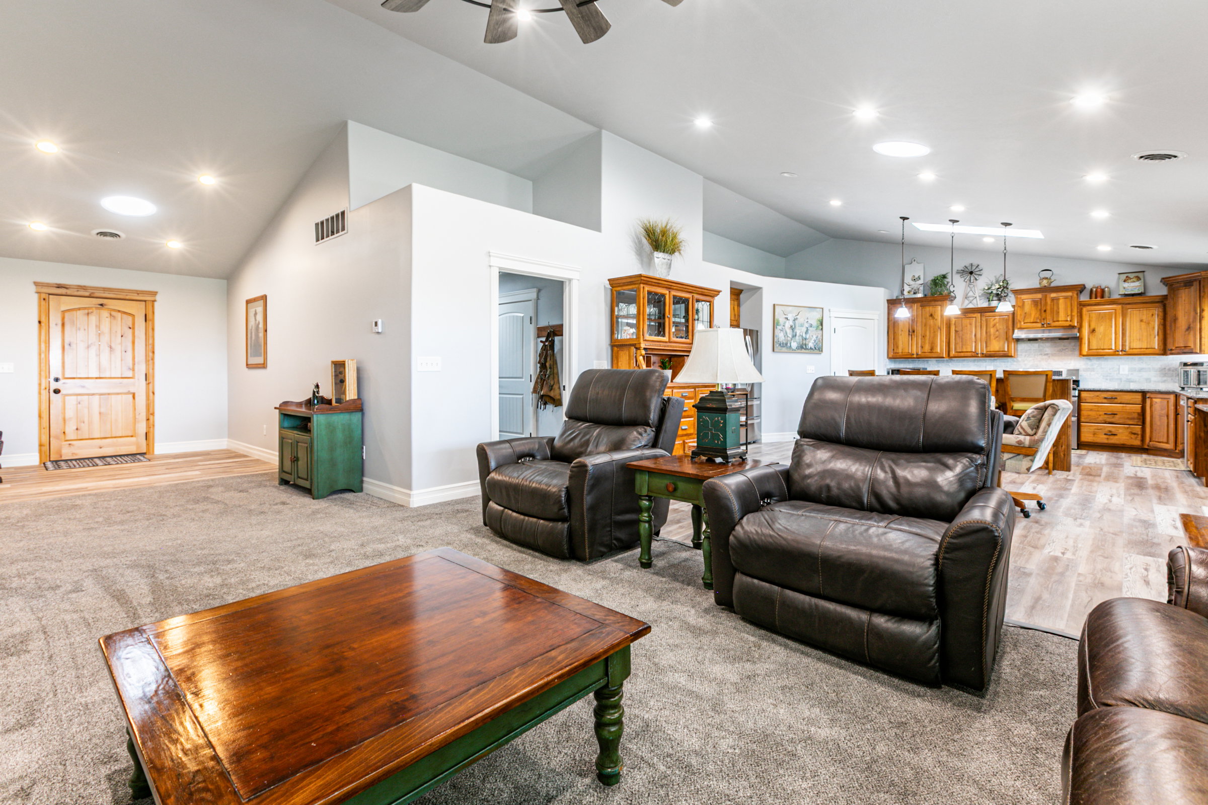 Spacious interior featuring vaulted ceilings and recessed lighting