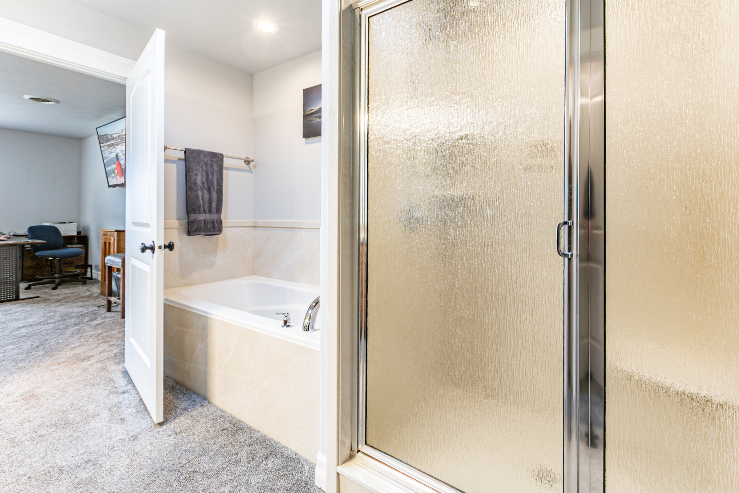 Frosted glass shower enclosure with chrome hardware