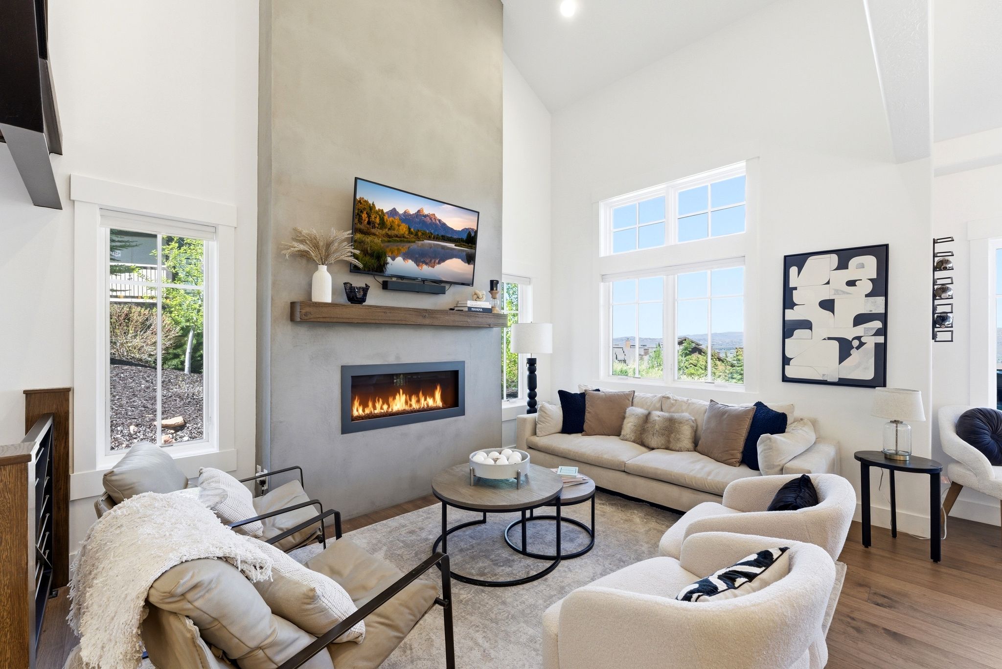 Vaulted ceiling living area featuring a full-height fireplace with a wood mantel