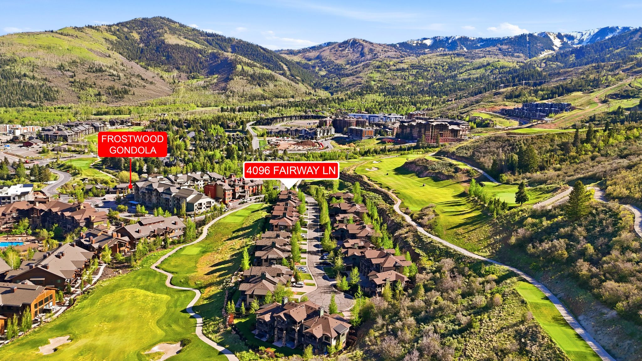 Aerial perspective showcasing properties nestled within a mountainous golf course community