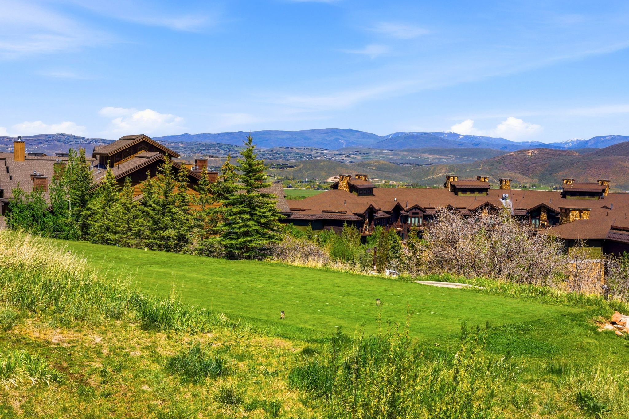 Expansive green lawn with mountain backdrop