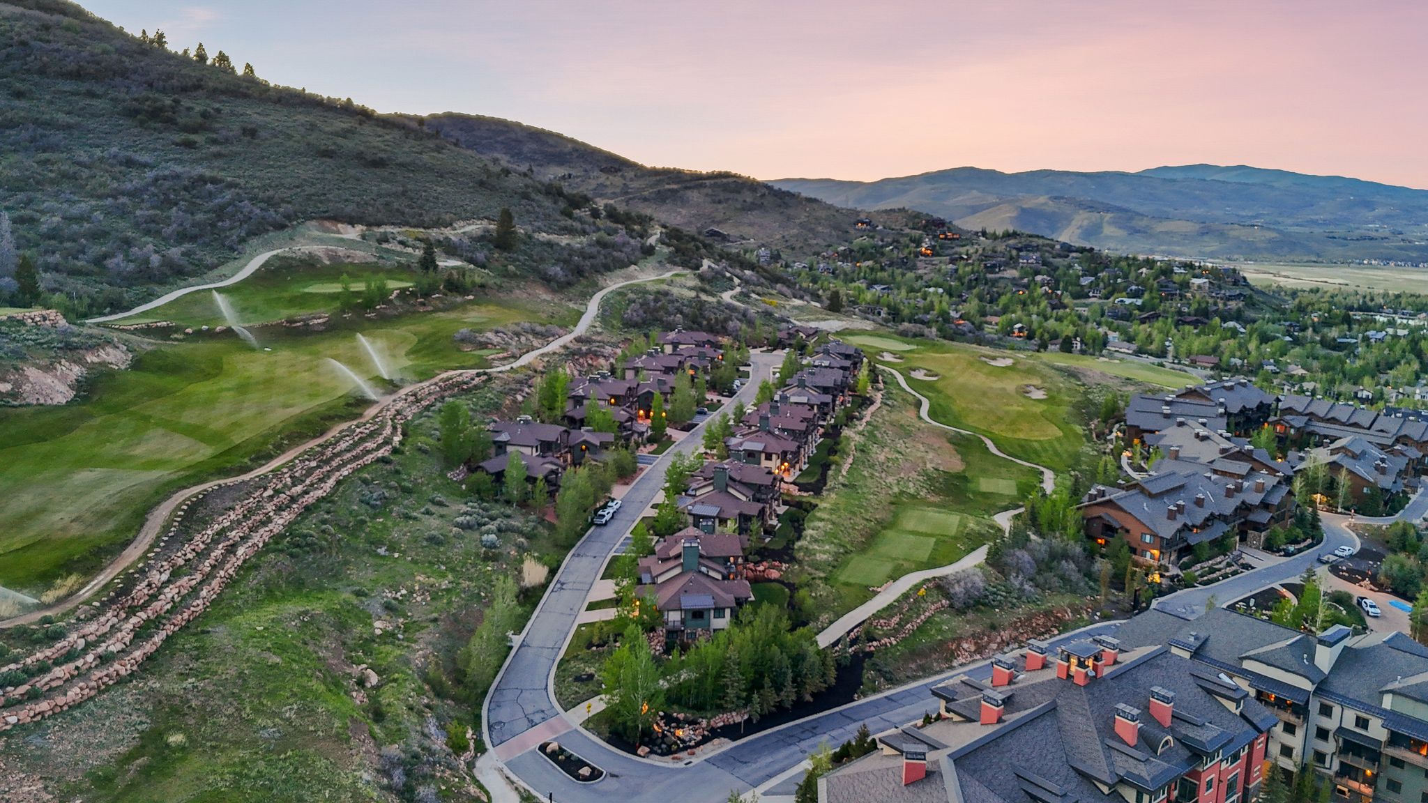Expansive mountain community showcasing multiple residential structures with dark roofs and light-colored siding