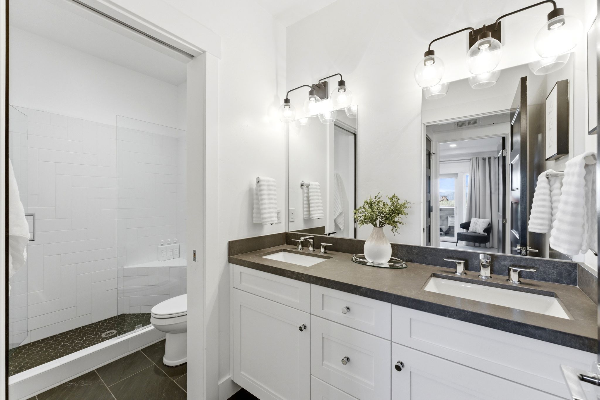 Dual vanity with undermount sinks and dark countertops