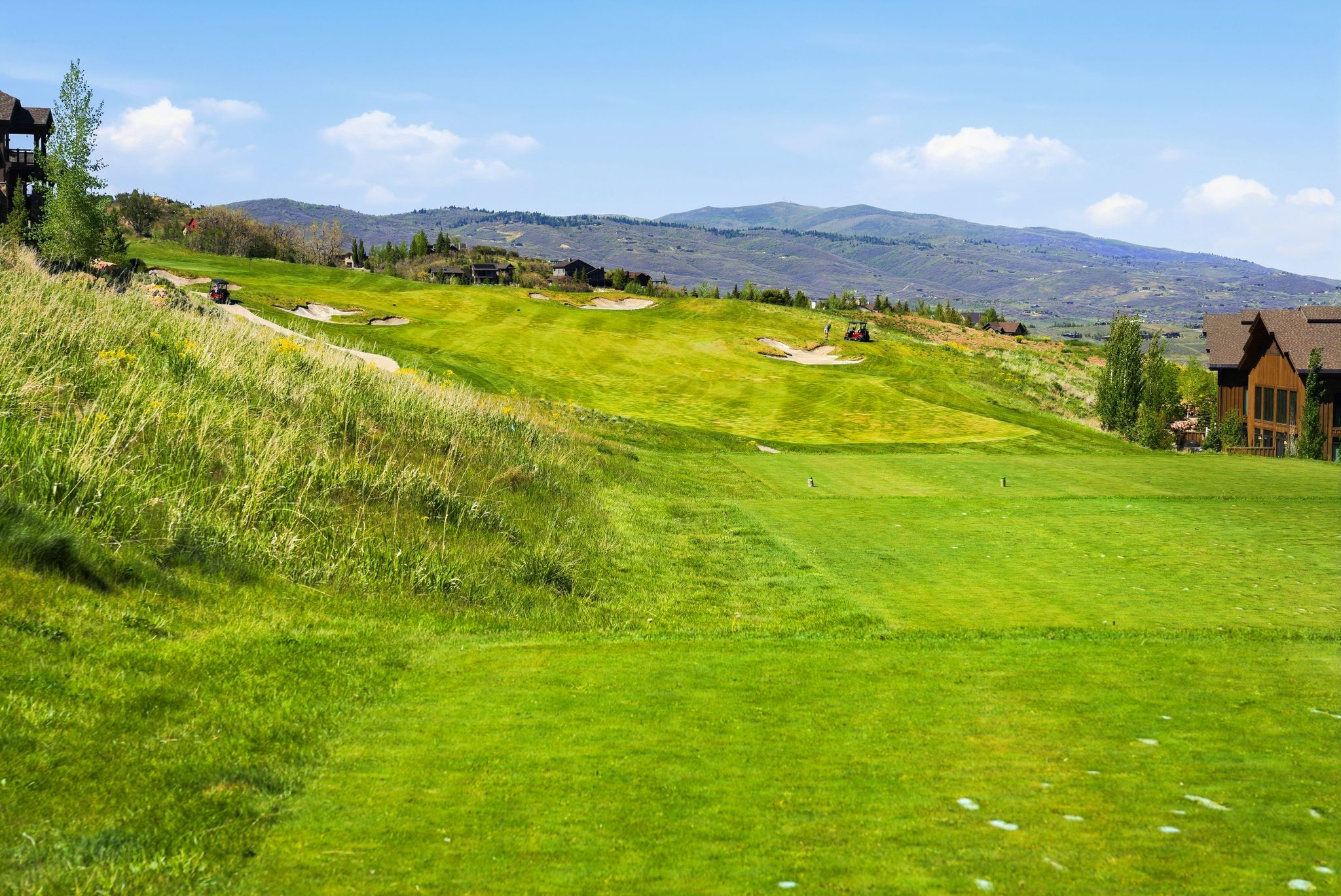 Expansive golf course featuring manicured greens and sand traps