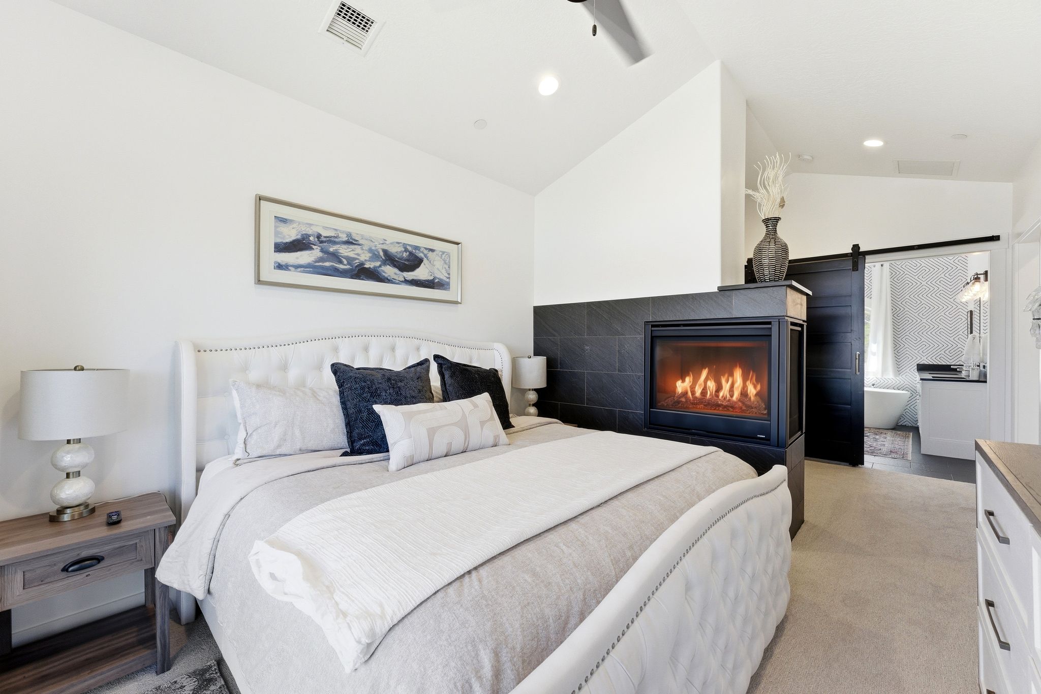Room featuring a modern fireplace with a dark tile surround