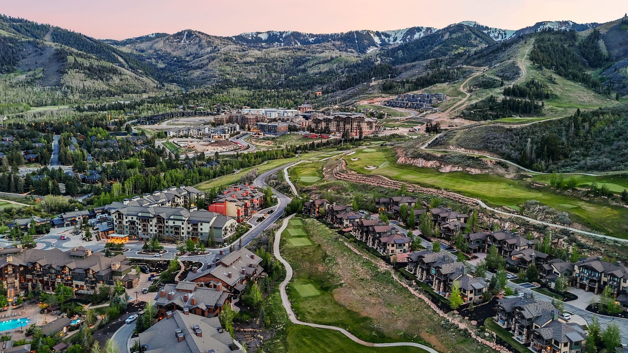 Expansive aerial perspective showcasing a mountainous landscape with snow-capped peaks