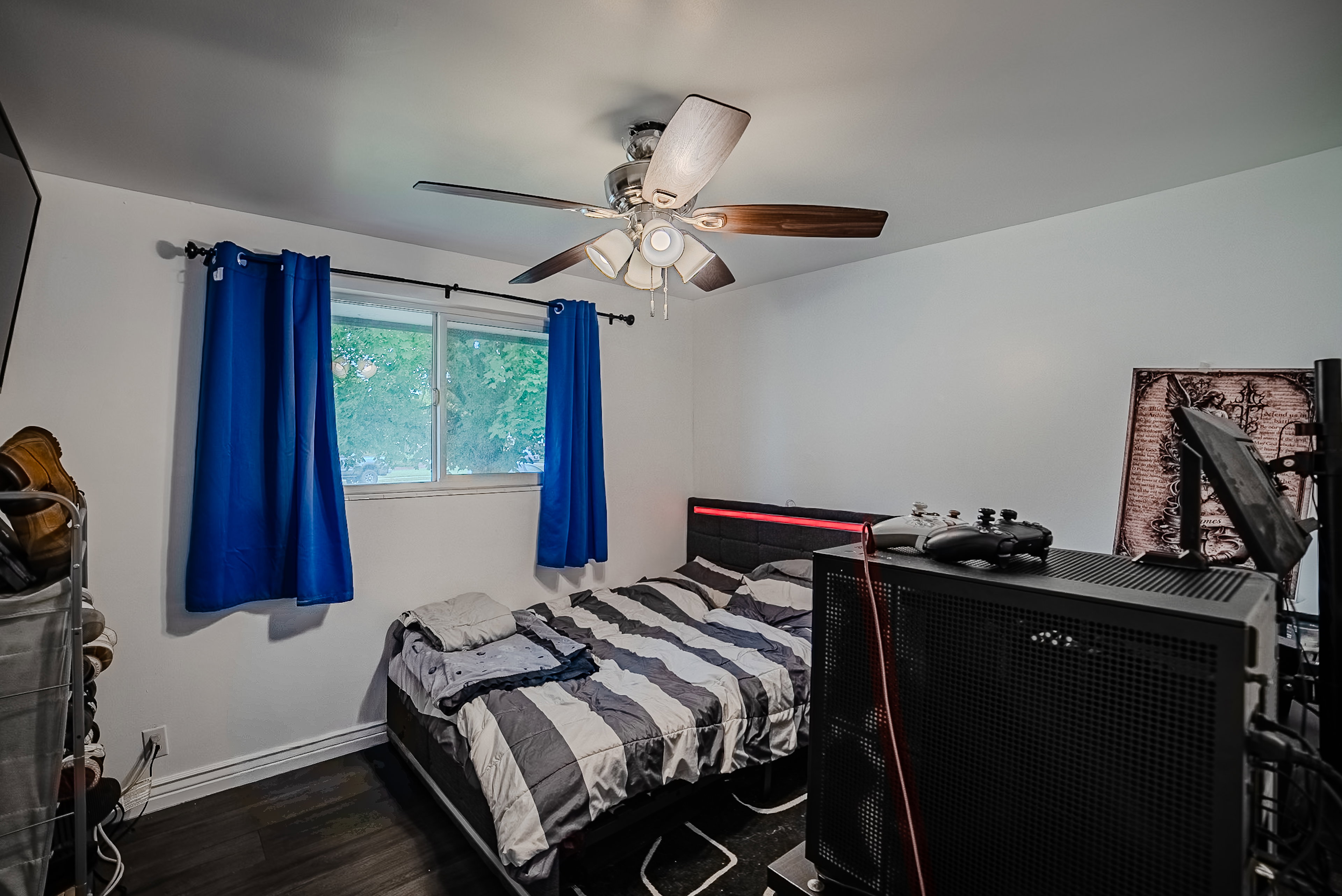 Bedroom featuring dark wood-finish flooring and a white baseboard