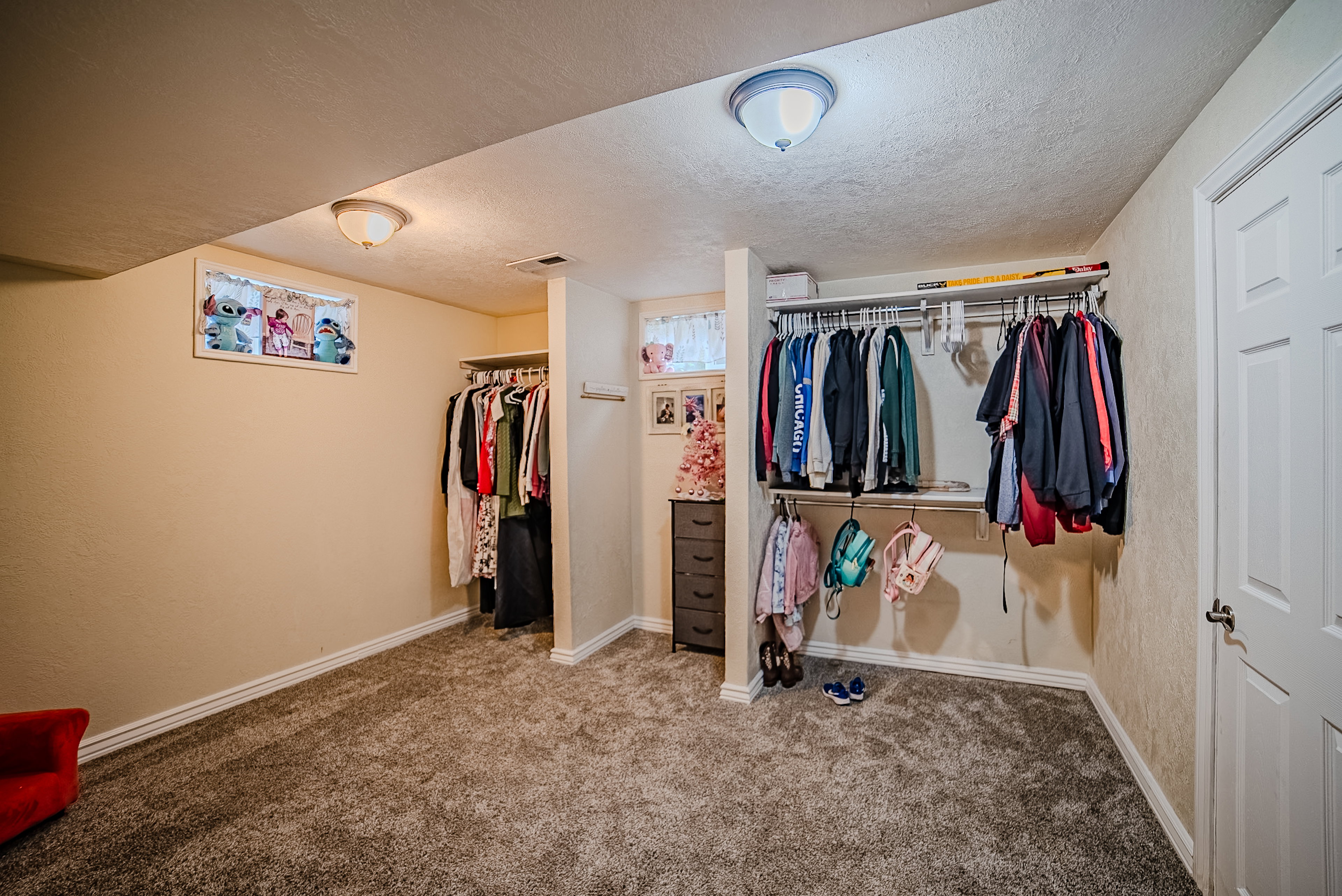 Spacious room featuring plush gray carpeting and neutral wall paint