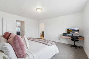 Spacious interior featuring light gray carpeting, crisp white walls, and a recessed ceiling light fixture