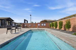 Rectangular swimming pool with integrated steps, surrounded by concrete decking