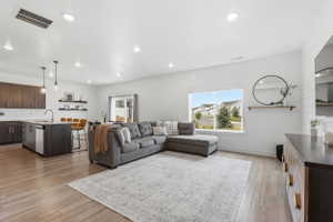 Open-concept living area featuring wood-finish flooring throughout