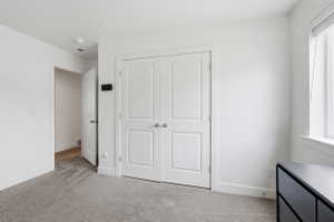 Bedroom 1. Neutral white walls with crisp baseboards and trim