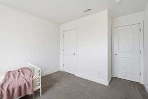 Bddroom 2. Bright interior room featuring neutral-toned carpet flooring and white painted walls