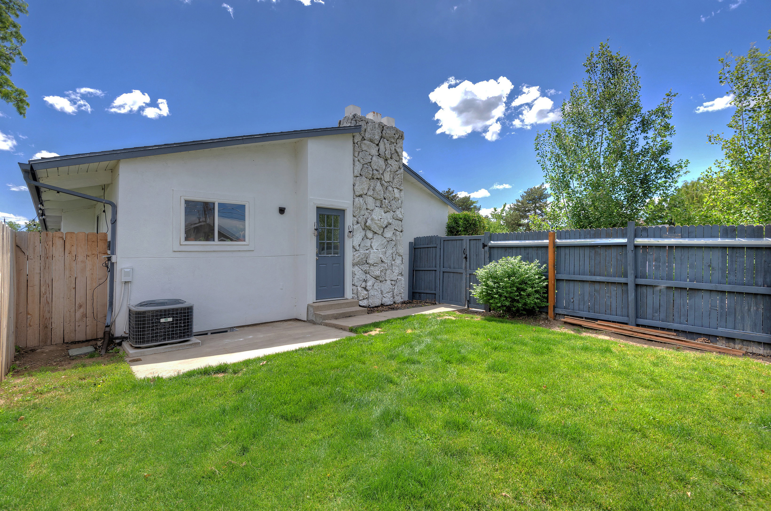 Expansive grassy yard with a concrete patio