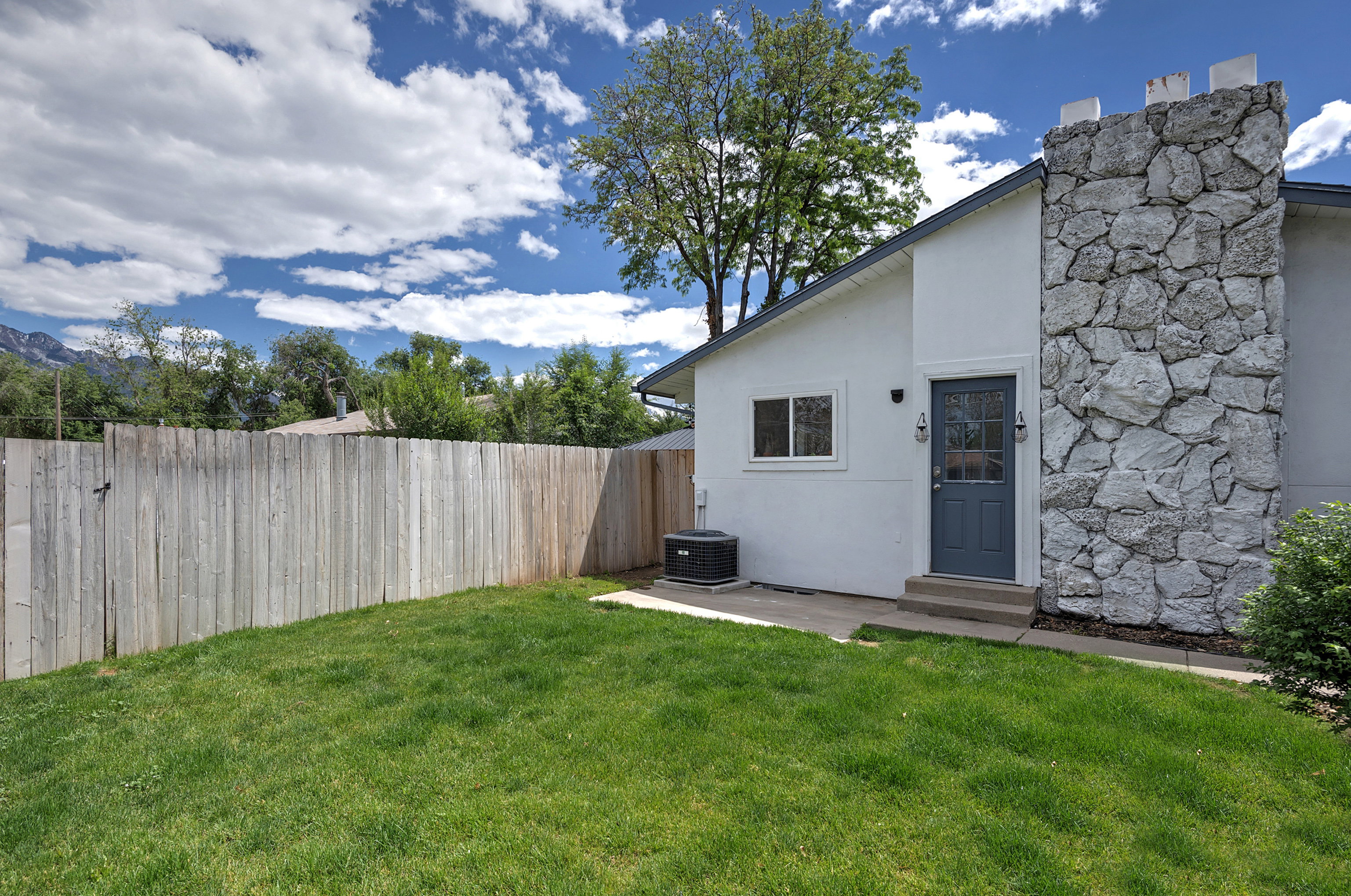 Expansive green lawn and tall privacy fencing