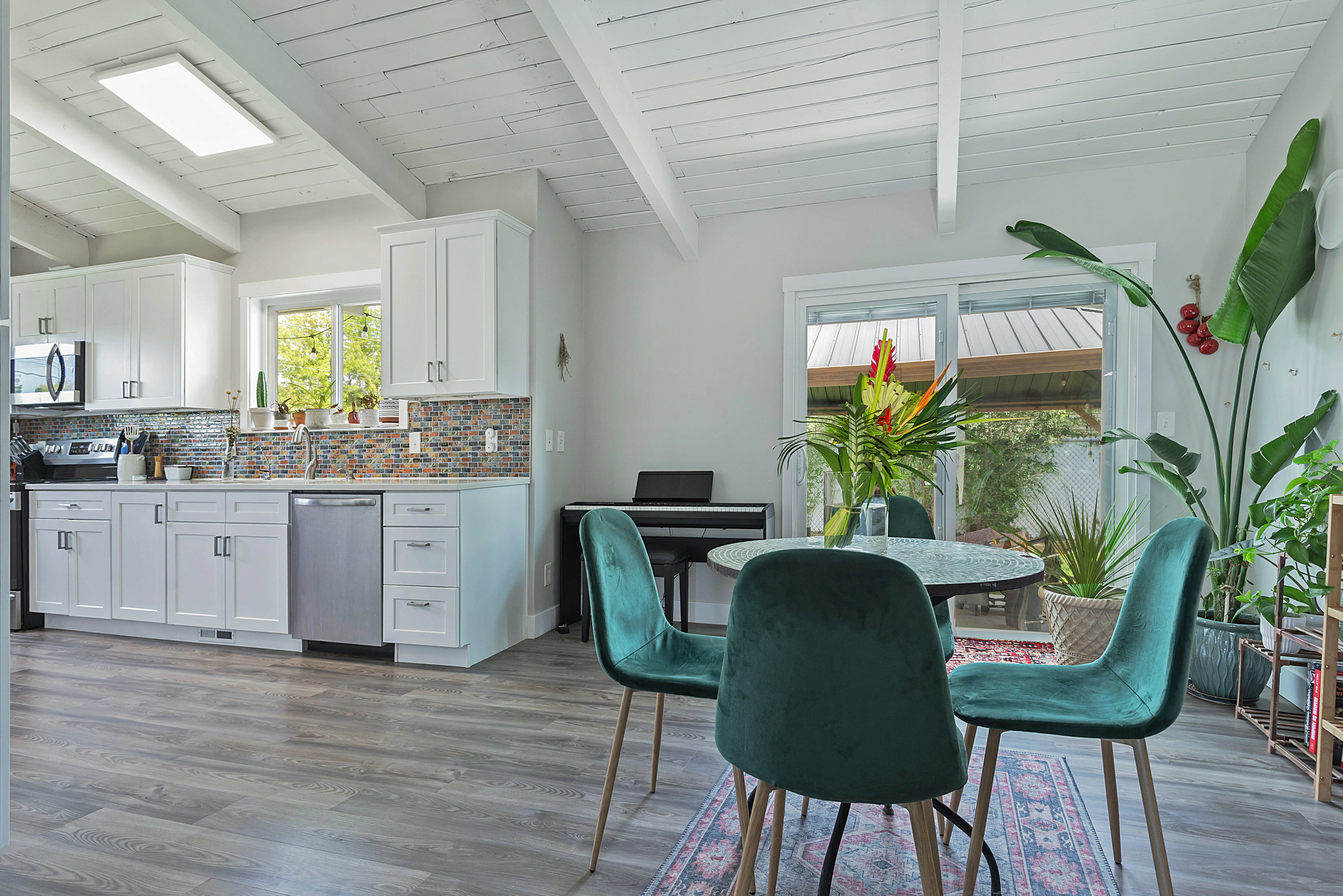 Modern kitchen with white cabinetry and stainless steel appliances