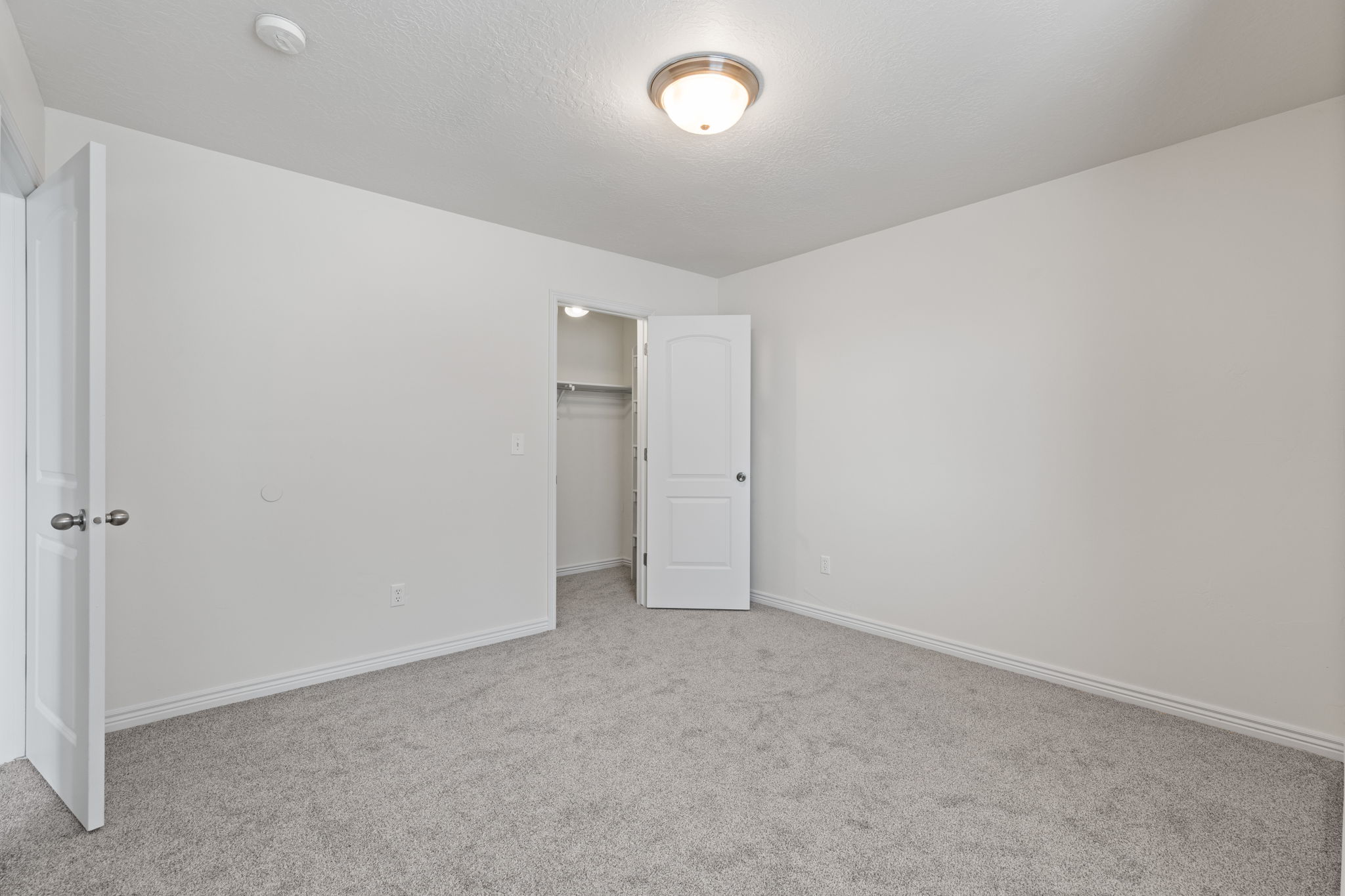 Spare bedroom with new carpet. fresh paint, and walk-in closet