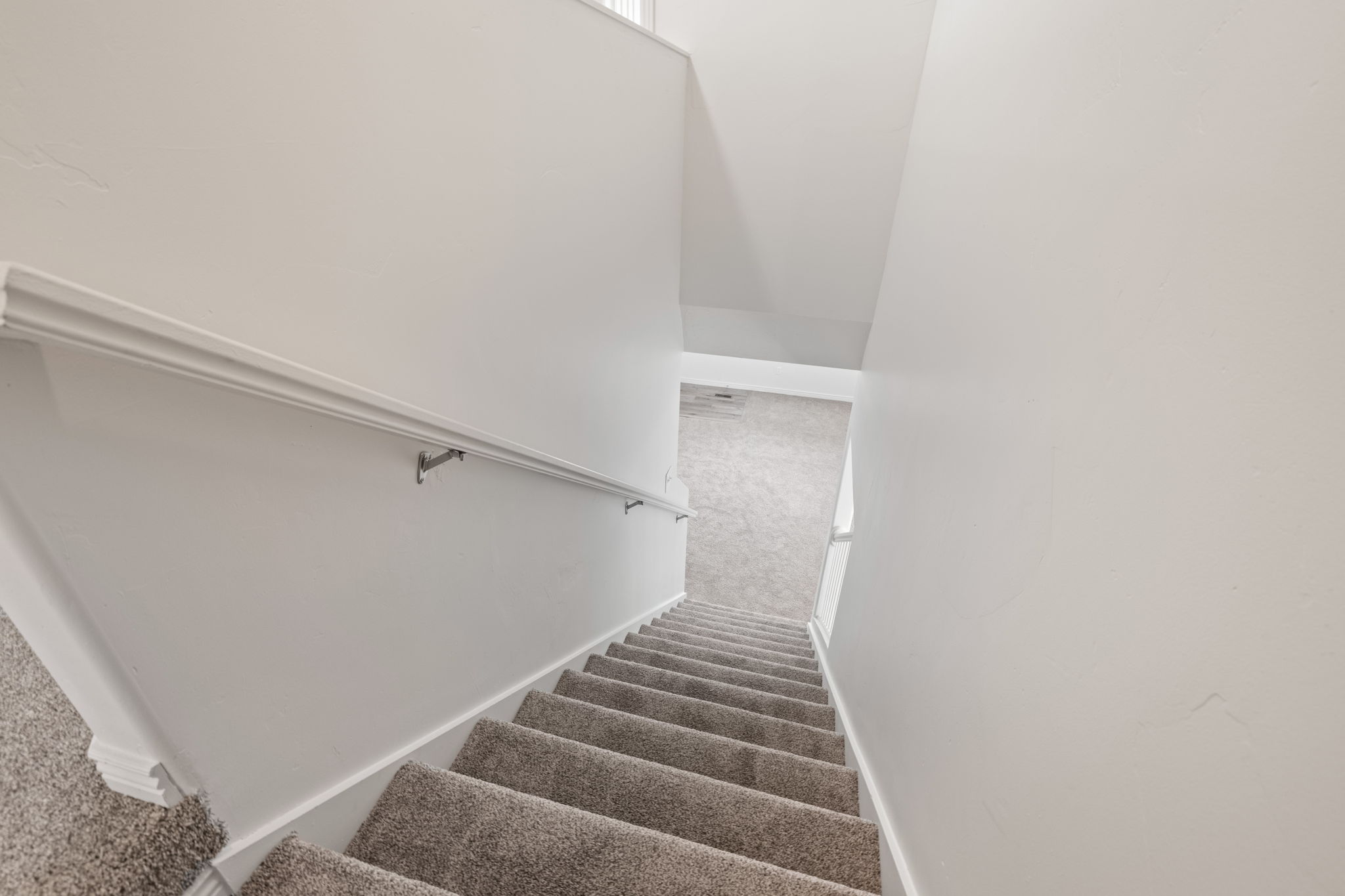 View of stairwell with new carpet and paint