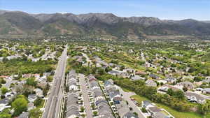Aerial perspective showcasing a residential area with a mountain backdrop
