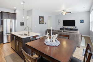 Modern kitchen island featuring a double-basin stainless steel sink, gooseneck faucet, and integrated dishwasher