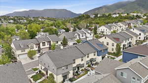 Aerial perspective of a residential community featuring varied architectural styles and mountain backdrops