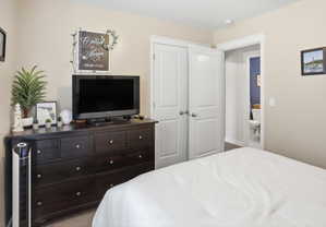 Bedroom featuring neutral wall tones, white trim, and carpeted flooring