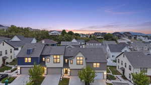 Modern townhomes featuring distinct architectural facades, attached garages, and individual driveways