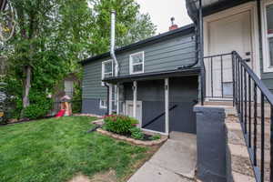 Expansive green lawn with mature trees and a dedicated garden bed
