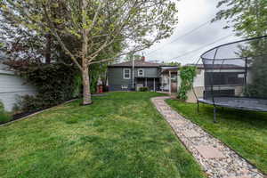 Expansive green lawn with mature trees and established landscaping