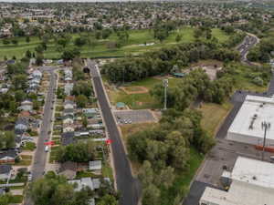 Aerial perspective showcasing a developed neighborhood, golf course, and 2 parks