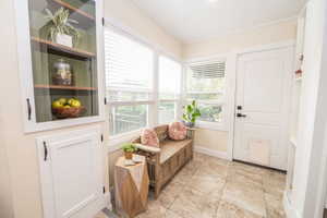 Entryway featuring light-toned tile flooring and abundant natural light from multiple windows