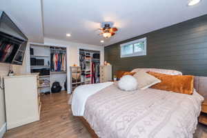 Primary Suite Bedroom featuring wood-finish flooring, recessed lighting, and a ceiling fan