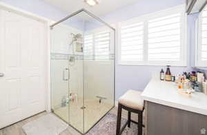 Glass-enclosed shower with tile surround and mosaic accent