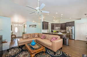 Open-concept living space featuring vaulted ceilings, a ceiling fan, and recessed lighting