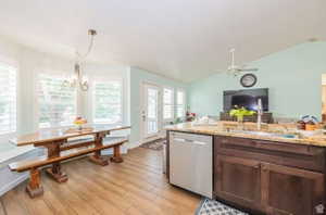 Kitchen with wood-finish flooring, dark wood cabinetry, and a light-toned granite countertop