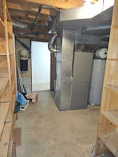Unfinished basement with exposed ceiling joists and ductwork, featuring a central air handler unit, water heater, and built-in wooden shelving