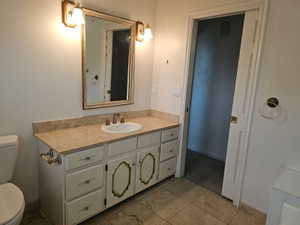 Bathroom vanity featuring an integrated oval sink, countertop, and wood-finish cabinetry