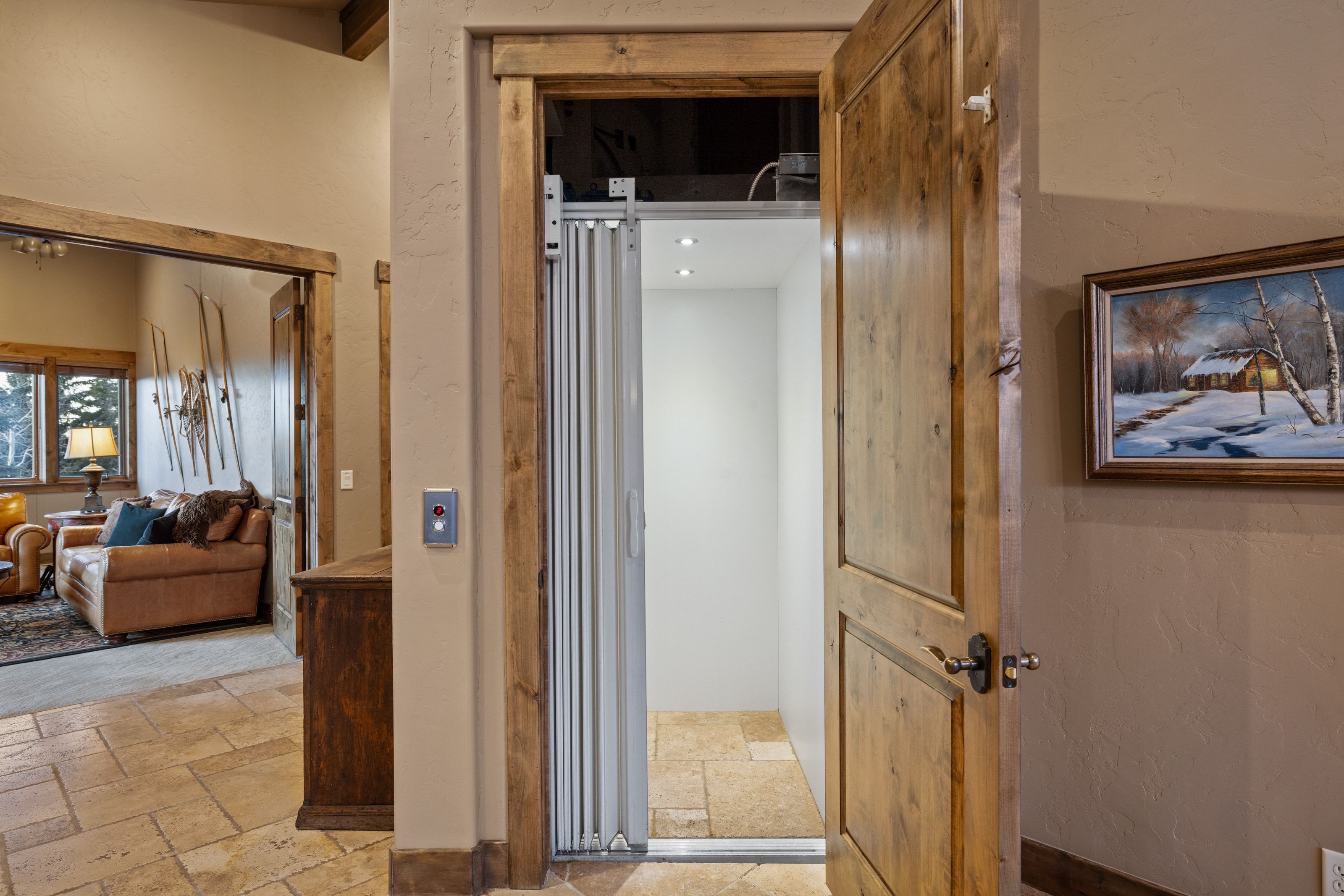Hall featuring stone tile flooring and elevator