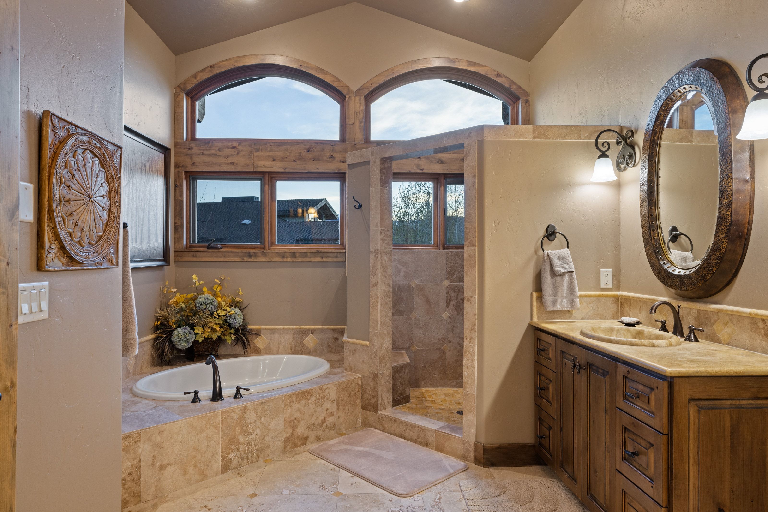 Full bath featuring vanity, walk in shower, a bath, and a textured wall