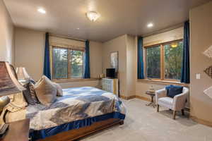 Carpeted bedroom with baseboards and recessed lighting
