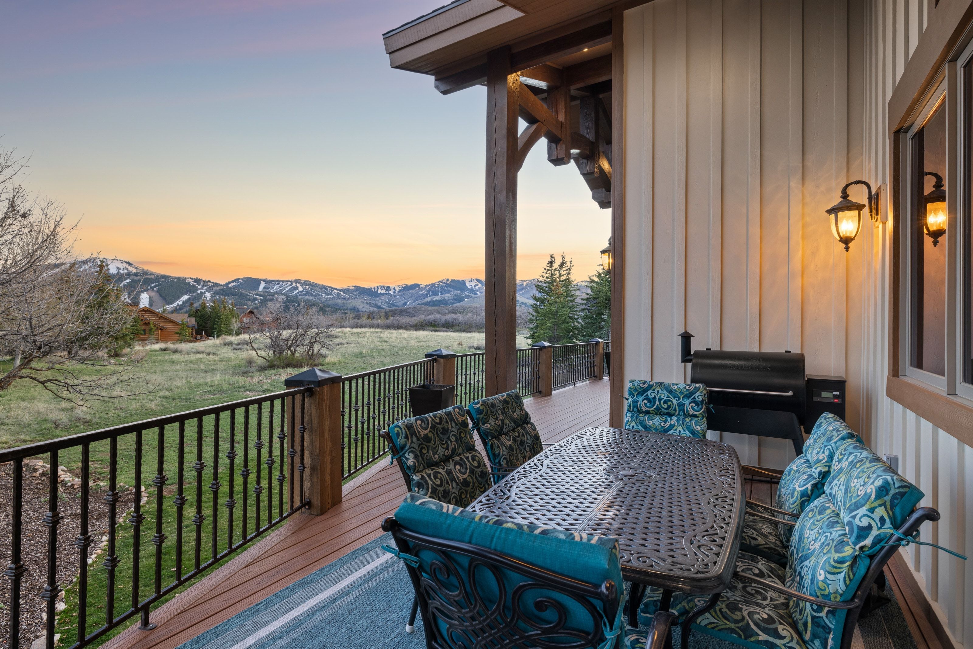 Wooden terrace with outdoor dining space and a mountain view
