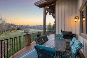 Wooden terrace with outdoor dining space and a mountain view